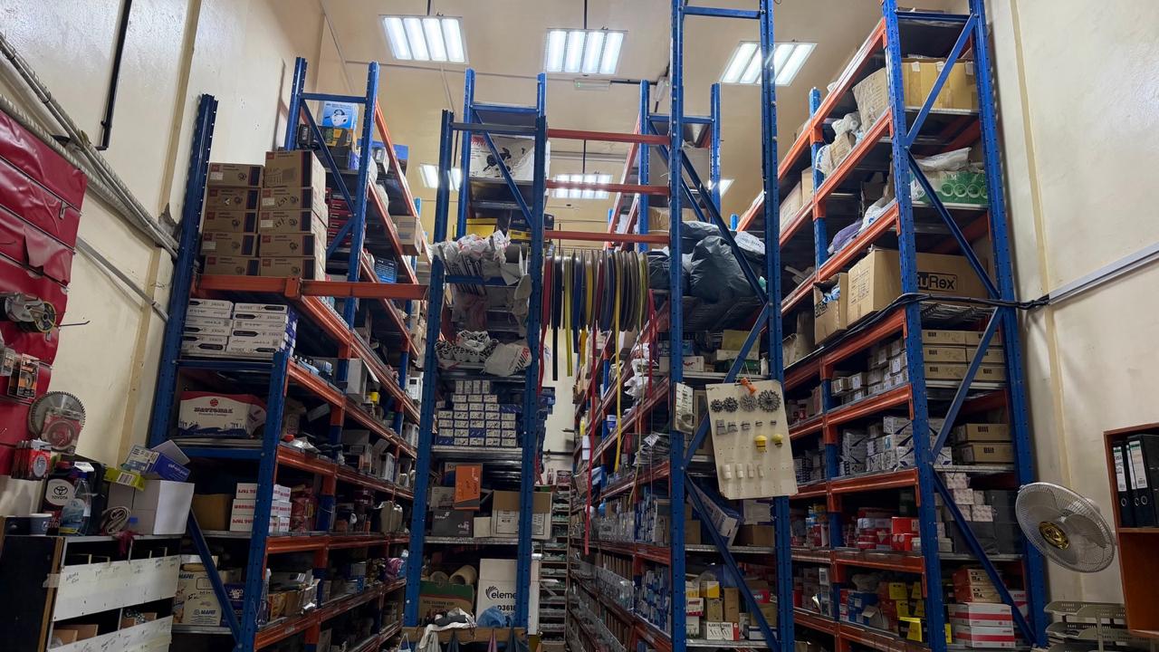 Warehouse aisle stocked with electrical, plumbing and hardware items